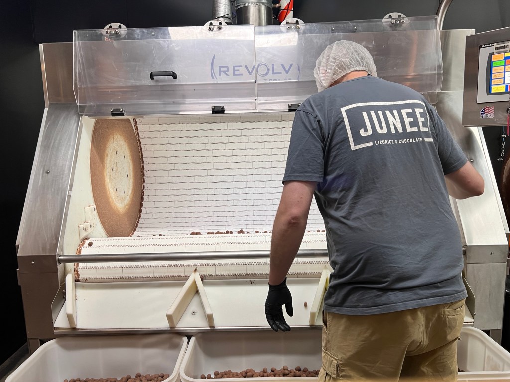Coating the peanuts in chocolate